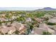 A high-angle view of a neatly planned neighborhood with homes with backyard pools, landscaping, parks, and greenery at 20412 W Thayer St, Buckeye, AZ 85396