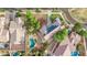 Aerial shot of a property showcasing a backyard pool, landscaping, solar panels, and neighborhood layout at 20412 W Thayer St, Buckeye, AZ 85396