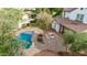 Aerial view shows a pristine pool, fire pit, and landscaped yard in a neatly planned residential neighborhood at 20412 W Thayer St, Buckeye, AZ 85396