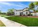 Large home featuring solar panels, manicured lawn, desert landscaping and cozy covered porch at 20412 W Thayer St, Buckeye, AZ 85396