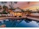Inviting backyard with a pool, string lights, patio, and landscaped grounds at 20412 W Thayer St, Buckeye, AZ 85396