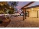 Outdoor living space with cozy backyard featuring a covered patio, pavers, fire pit, and string lights at 20412 W Thayer St, Buckeye, AZ 85396