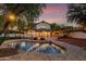 Backyard with a pool, patio, firepit, and string lights, perfect for outdoor enjoyment at 20412 W Thayer St, Buckeye, AZ 85396