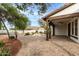 Expansive backyard patio with outdoor kitchen, fire pit, pergola, and lush landscaping at 20412 W Thayer St, Buckeye, AZ 85396