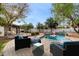 An inviting backyard with a lounge area, pool, and manicured landscaping at 20412 W Thayer St, Buckeye, AZ 85396