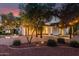 Landscaped backyard with covered patio, outdoor lighting, and fire pit at 20412 W Thayer St, Buckeye, AZ 85396