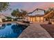 Twilight backyard showcasing a pool, cozy patio, and string lights creating a magical outdoor retreat at 20412 W Thayer St, Buckeye, AZ 85396