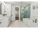Elegant bathroom featuring a soaking tub, glass-enclosed shower, and quartz countertops at 20412 W Thayer St, Buckeye, AZ 85396