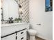 Modern bathroom featuring black and white floral patterned backsplash at 20412 W Thayer St, Buckeye, AZ 85396