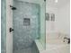 Luxurious bathroom featuring a glass shower, soaking tub, and designer tile at 20412 W Thayer St, Buckeye, AZ 85396