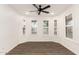 A spacious bedroom with hard flooring, white shutters, and ceiling fan at 20412 W Thayer St, Buckeye, AZ 85396