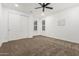 A bedroom features carpeted floors, a closet, and a double-hung window with white walls at 20412 W Thayer St, Buckeye, AZ 85396