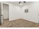 Bedroom with a ceiling fan, carpet and an opening into another room at 20412 W Thayer St, Buckeye, AZ 85396