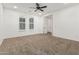 A bright bedroom with a ceiling fan, carpeted floors, and a double-hung window to let in the natural light at 20412 W Thayer St, Buckeye, AZ 85396