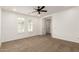 A clean bedroom with carpet, white shutters, and ceiling fan at 20412 W Thayer St, Buckeye, AZ 85396