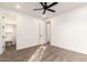 Bedroom with carpet, ceiling fan, white walls, and hallway and closet access at 20412 W Thayer St, Buckeye, AZ 85396