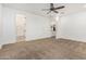 Bedroom featuring ceiling fan and an arched entryway into another room at 20412 W Thayer St, Buckeye, AZ 85396