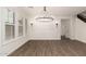 Bright dining room with wood floors, plantation shutters, modern chandelier, and access to stairs at 20412 W Thayer St, Buckeye, AZ 85396