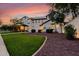 Gorgeous two-story home with solar panels, covered porch, and lush green lawn, exuding curb appeal at 20412 W Thayer St, Buckeye, AZ 85396