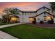 Beautiful two-story home with a well-maintained lawn, complemented by mature trees and professional landscaping at 20412 W Thayer St, Buckeye, AZ 85396