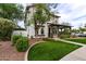 Attractive home featuring a covered porch, lush lawn, and manicured landscaping at 20412 W Thayer St, Buckeye, AZ 85396