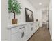 Hallway features white cabinets, countertop, tree and horse artwork at 20412 W Thayer St, Buckeye, AZ 85396