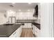 Bright kitchen boasts white cabinets, stainless steel appliances, and a large island with a black countertop at 20412 W Thayer St, Buckeye, AZ 85396