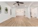 Open-concept living space with arched entryway and modern light fixture at 20412 W Thayer St, Buckeye, AZ 85396