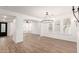 Bright living room featuring wood floors, an elegant chandelier, and large windows with shutters at 20412 W Thayer St, Buckeye, AZ 85396