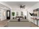 Bright living room featuring hardwood floors, contemporary furnishings, and a ceiling fan at 20412 W Thayer St, Buckeye, AZ 85396