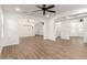 Open floor plan with wood floors, archways, and modern chandelier lighting throughout home at 20412 W Thayer St, Buckeye, AZ 85396