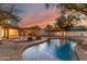 Sparkling pool and brick patio with string lights and fire pit offer outdoor relaxation at 20412 W Thayer St, Buckeye, AZ 85396