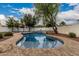 Inviting backyard featuring a refreshing pool, mature trees, and lush landscaping at 20412 W Thayer St, Buckeye, AZ 85396