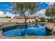 A backyard oasis showcasing a refreshing pool, mature trees, and lush landscaping at 20412 W Thayer St, Buckeye, AZ 85396