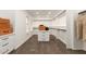 Bright walk-in closet with built-in shelving, drawers and neutral carpet at 20412 W Thayer St, Buckeye, AZ 85396