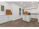 A spacious walk-in closet features custom drawers, an island, shelving, and carpet flooring at 20412 W Thayer St, Buckeye, AZ 85396