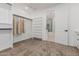 A spacious walk-in closet with shelving, hanging rods and a doorway that opens into an ensuite bathroom at 20412 W Thayer St, Buckeye, AZ 85396