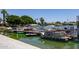 A community boat dock hosts several covered boats under blue skies and mature desert trees at 2309 W Naranja Ave, Mesa, AZ 85202