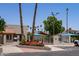 Community pool area with palm trees, umbrellas, and well-maintained fencing at 2309 W Naranja Ave, Mesa, AZ 85202