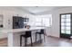 Kitchen featuring an island with bar seating, stainless appliances, and lots of light at 2309 W Naranja Ave, Mesa, AZ 85202