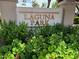 Well-maintained entrance sign for Laguna Park with lush greenery and flowers at 2309 W Naranja Ave, Mesa, AZ 85202