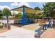 Modern playground with multiple play areas, seating, and safety features at 2309 W Naranja Ave, Mesa, AZ 85202