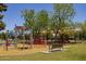 Well-maintained playground with colorful equipment and a shaded seating area at 2309 W Naranja Ave, Mesa, AZ 85202