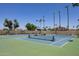 Tennis courts at the Dobson Ranch community with shaded benches, tall trees, and lush desert landscaping at 2309 W Naranja Ave, Mesa, AZ 85202