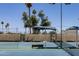 Tennis court at the Dobson Ranch community with shaded benches under tall trees on a clear day at 2309 W Naranja Ave, Mesa, AZ 85202