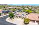 Stunning aerial view of a home with solar panels on the roof, surrounded by well-kept lawns and desert landscaping at 2405 W Memorial Dr, Anthem, AZ 85086