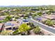 Wide aerial of neighborhood featuring houses with solar panels, well-maintained yards, and desert landscaping at 2405 W Memorial Dr, Anthem, AZ 85086
