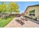 Backyard patio features a manicured lawn, brick pavers, a hot tub, and lounge chairs at 2405 W Memorial Dr, Anthem, AZ 85086