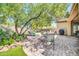 Beautiful backyard featuring a paved patio, lush landscaping, and mature trees at 2405 W Memorial Dr, Anthem, AZ 85086