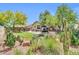 Backyard with artificial lawn, desert landscaping, brick patio, hot tub, and patio seating at 2405 W Memorial Dr, Anthem, AZ 85086